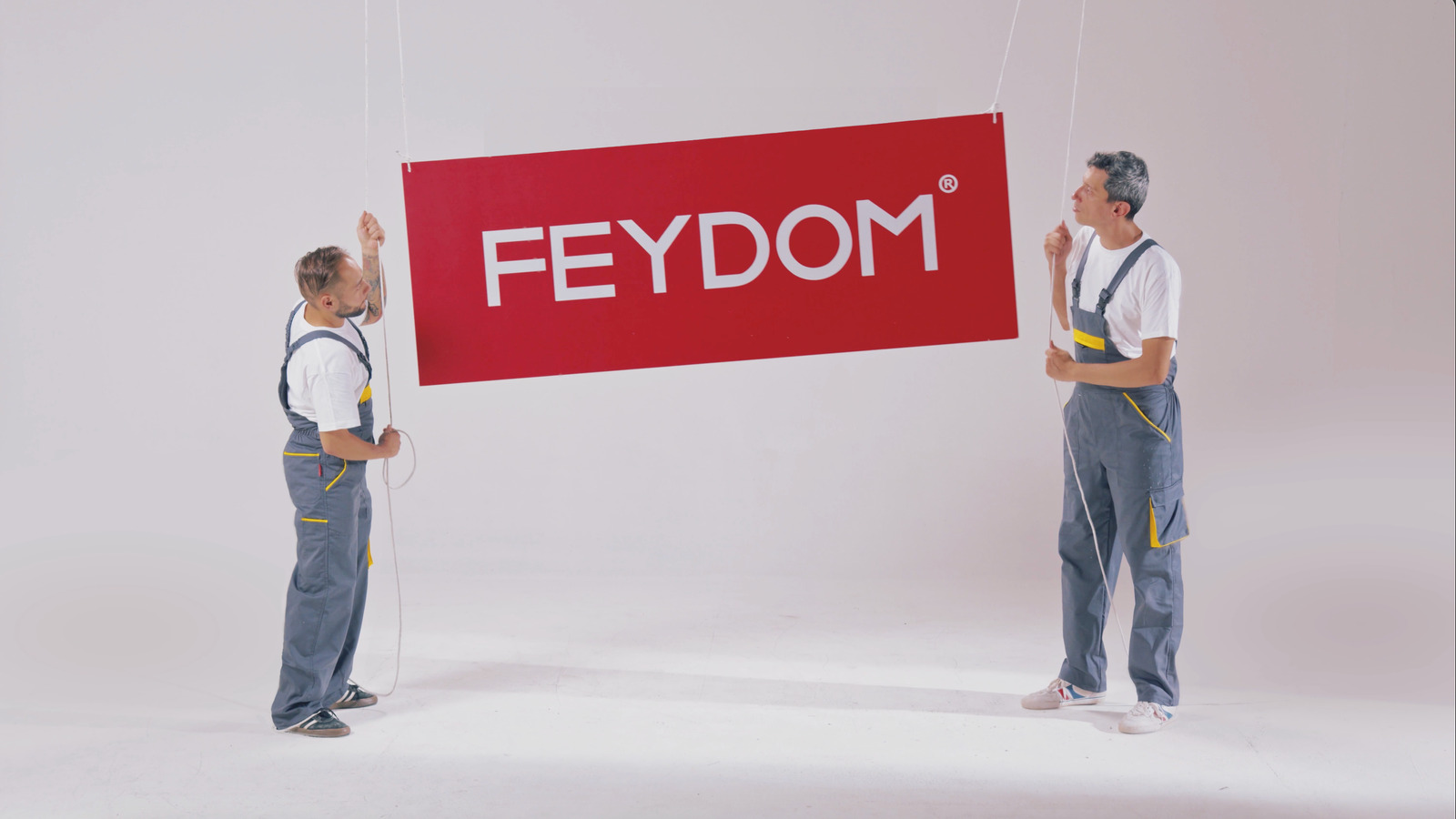People holding the Feydom logo